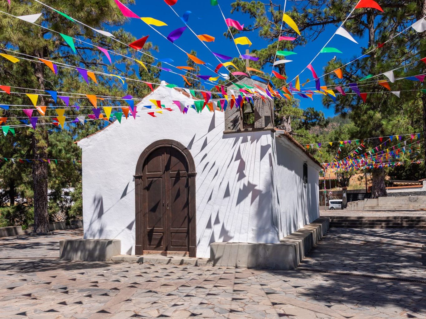 Vilaflor's little white chapel decorated with colorful bunting for the patron saint festival