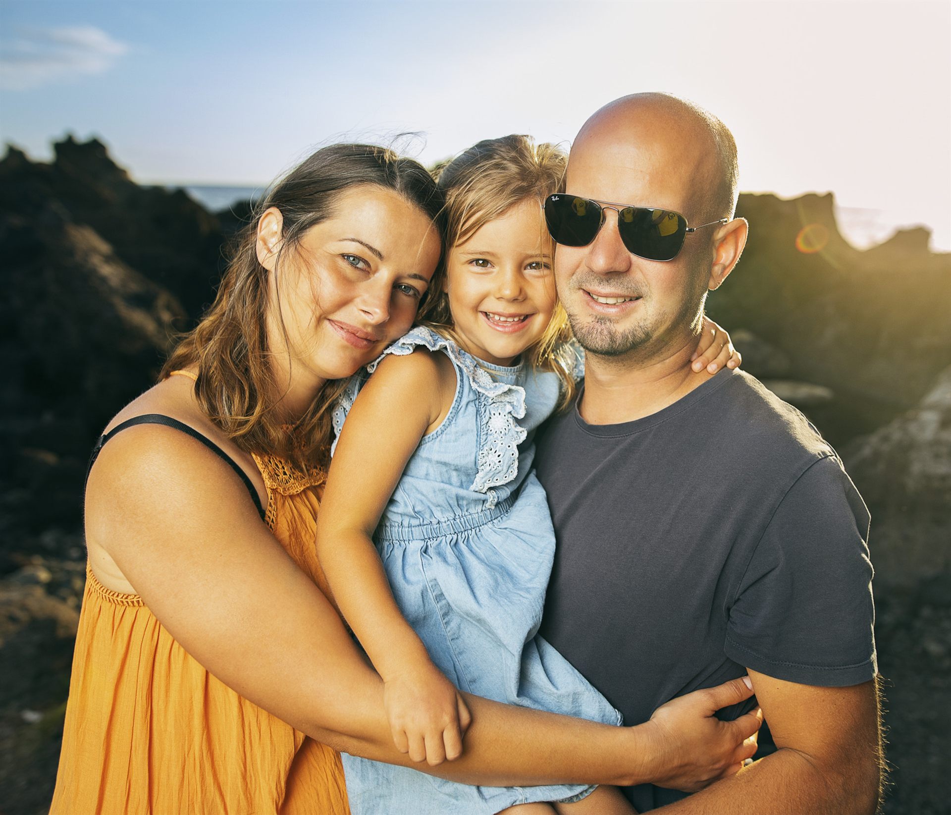 Young family at sunset on the wild volcanic beach of Playa la Arena